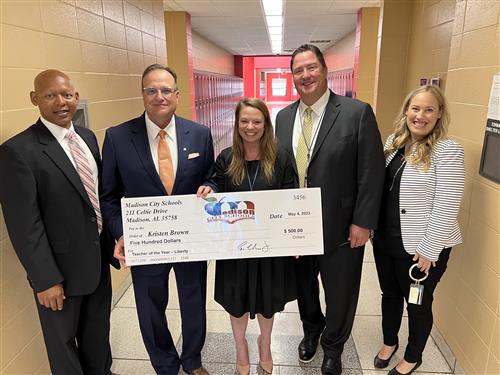Kristen Brown with oversized check and prize patrol